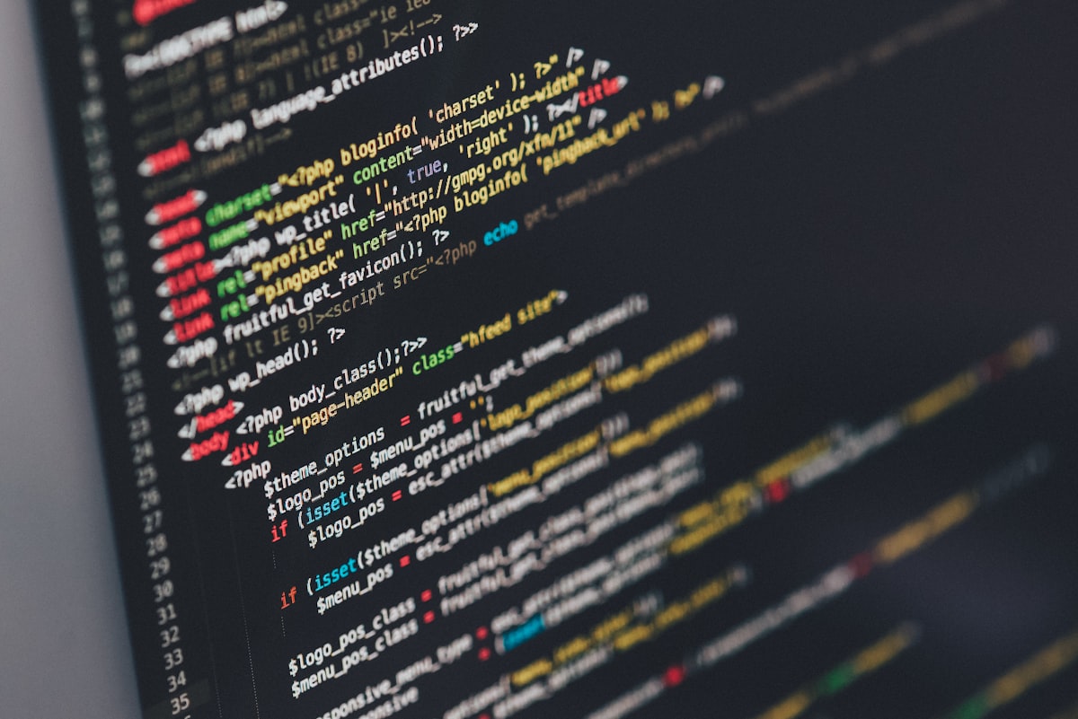 Software developer writing code on computer screen
